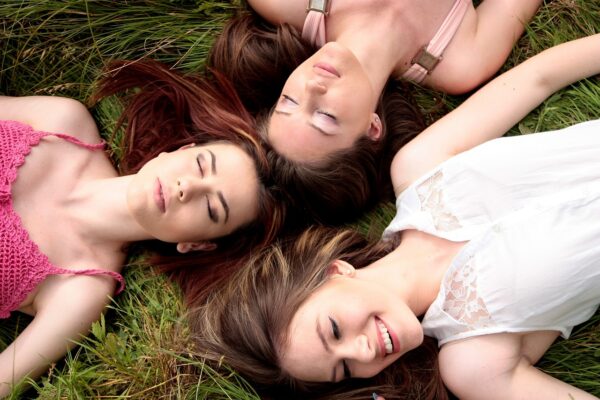 women friends meadow lying girls 1487825